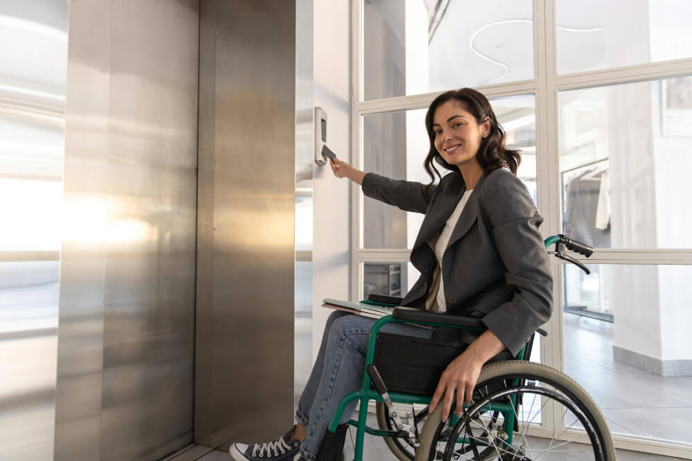 Empresária com deficiência em cadeira de rodas à espera do elevador no escritório no trabalho
