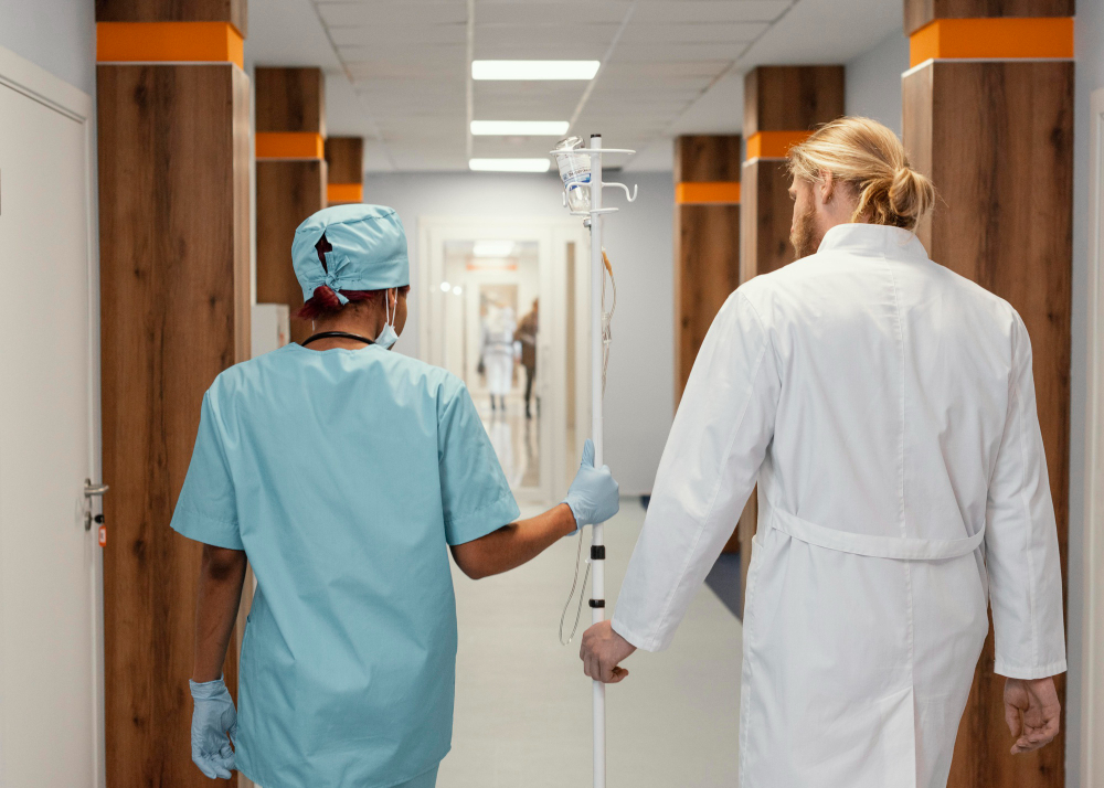 A imagem mostra dois médicos indo ao elevador